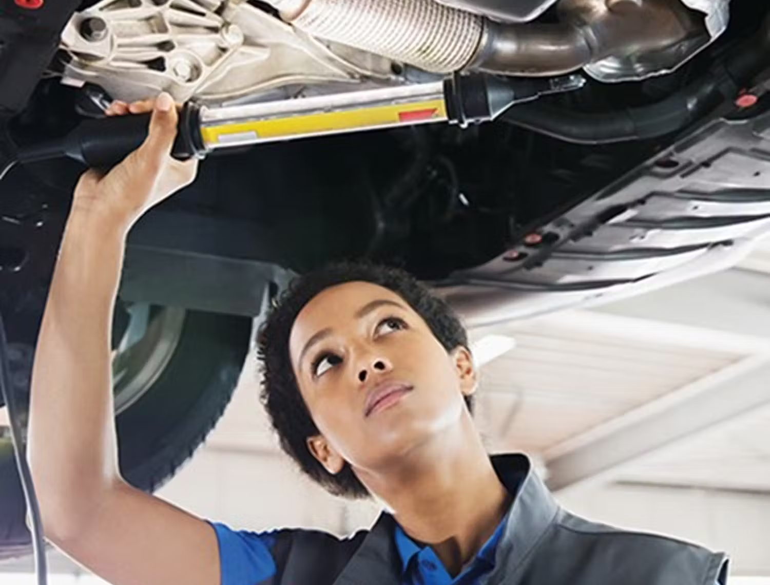 person looking under car