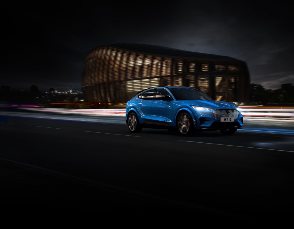 Blue mustang being driven at night