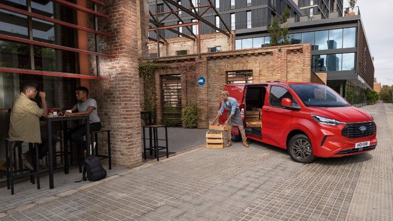 man stacking palettes out of van 