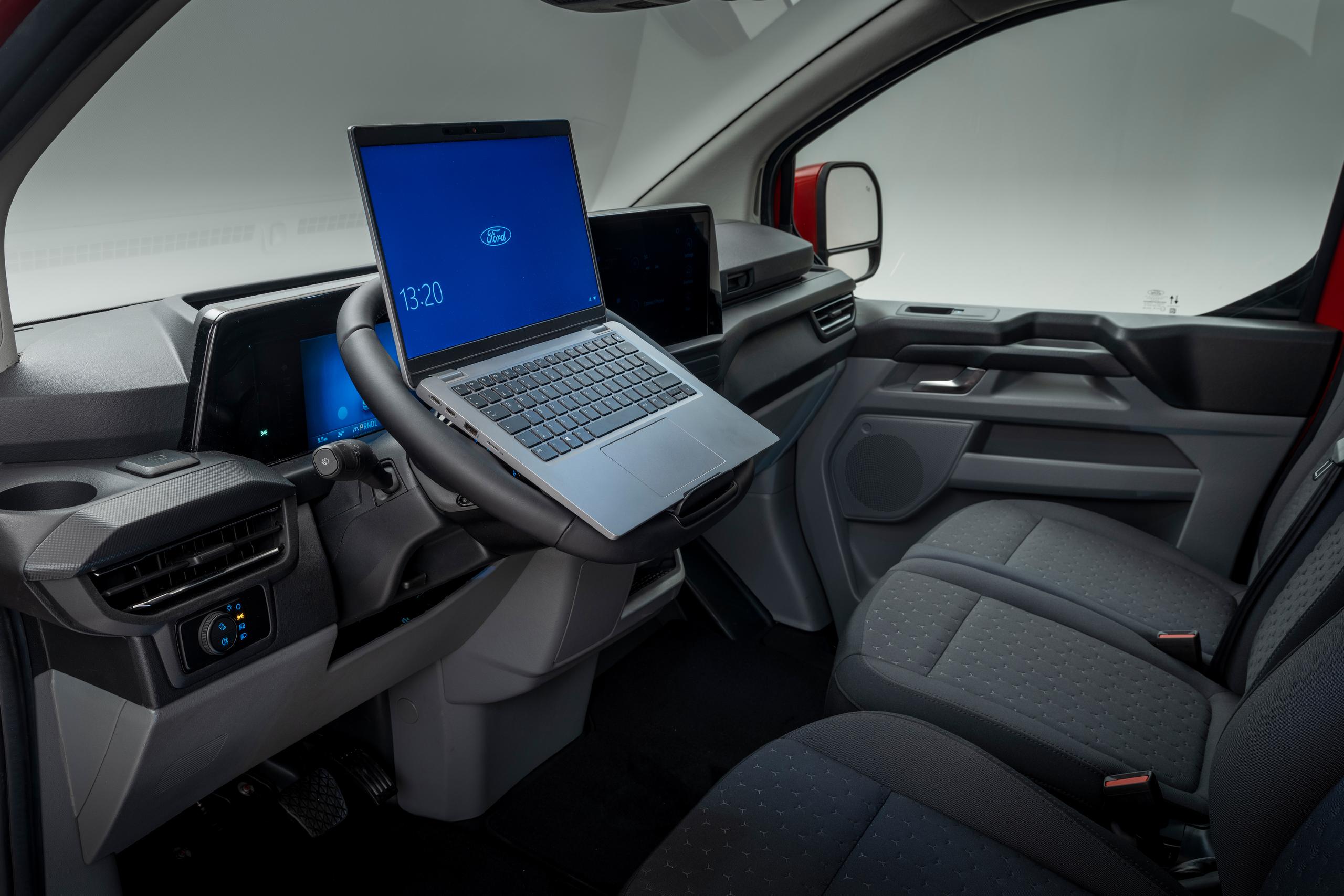 Interior of van with laptop on steering wheel