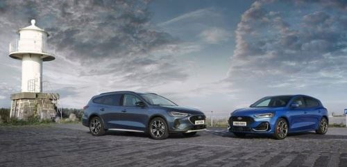 2 blue ford focuses by lighthouse